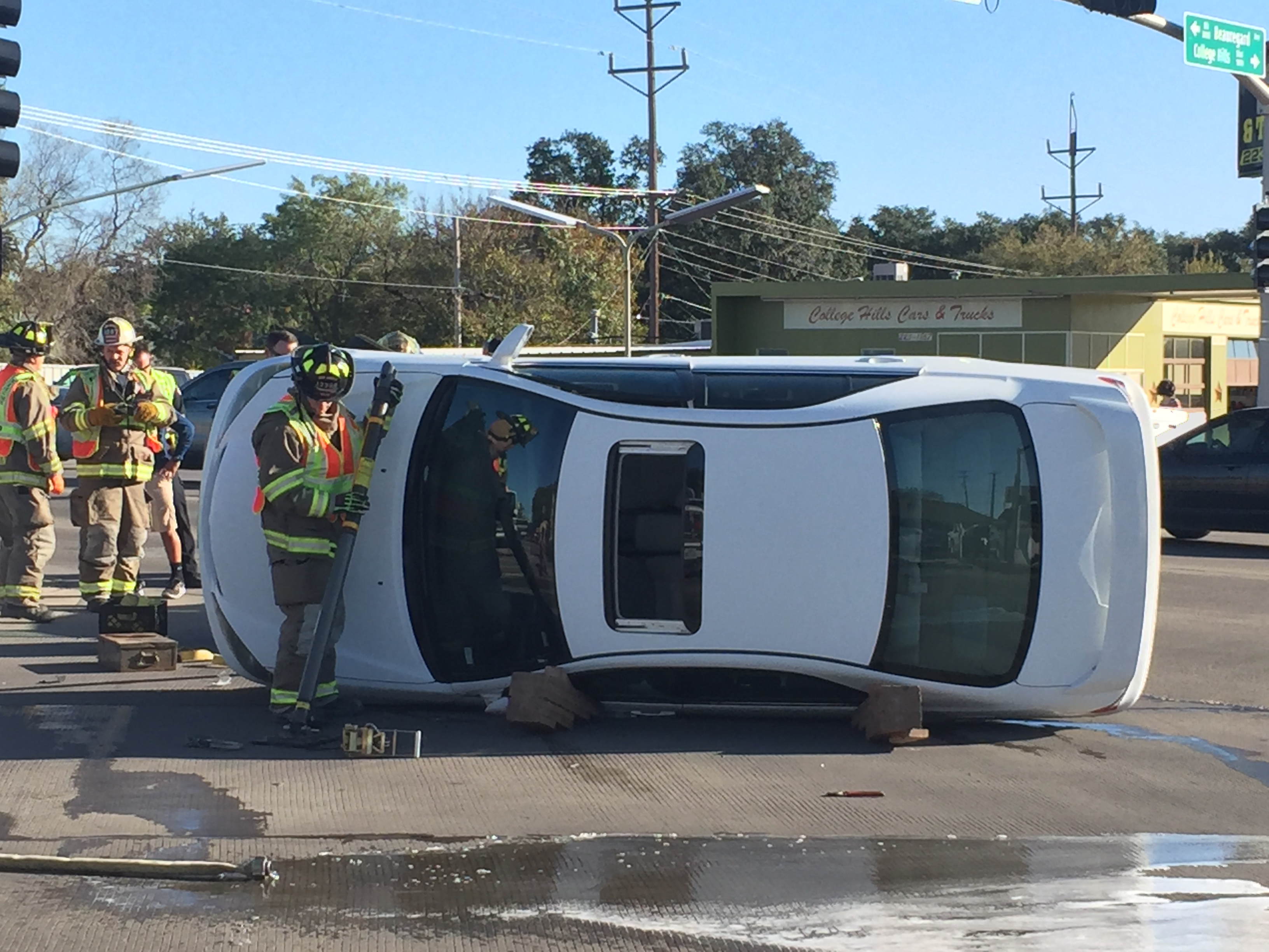 A white sedan flipped over on College Hills after collision. (LIVE! Photo/Megan Holmquest) A white sedan flipped over on College Hills after collision. (LIVE! Photo/Megan Holmquest)