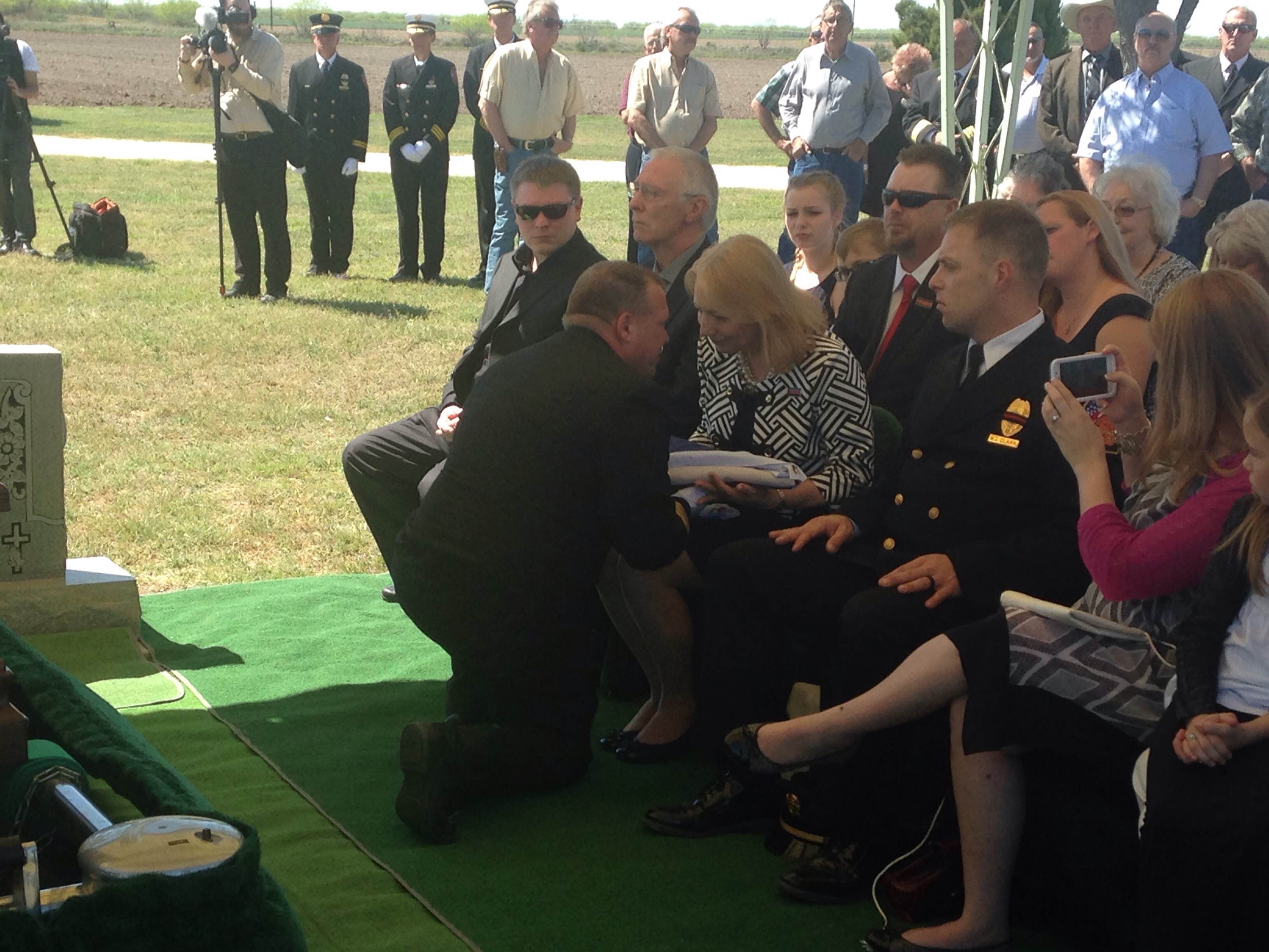 Fire Chief Dunn hands Texas flag to Pat Clark