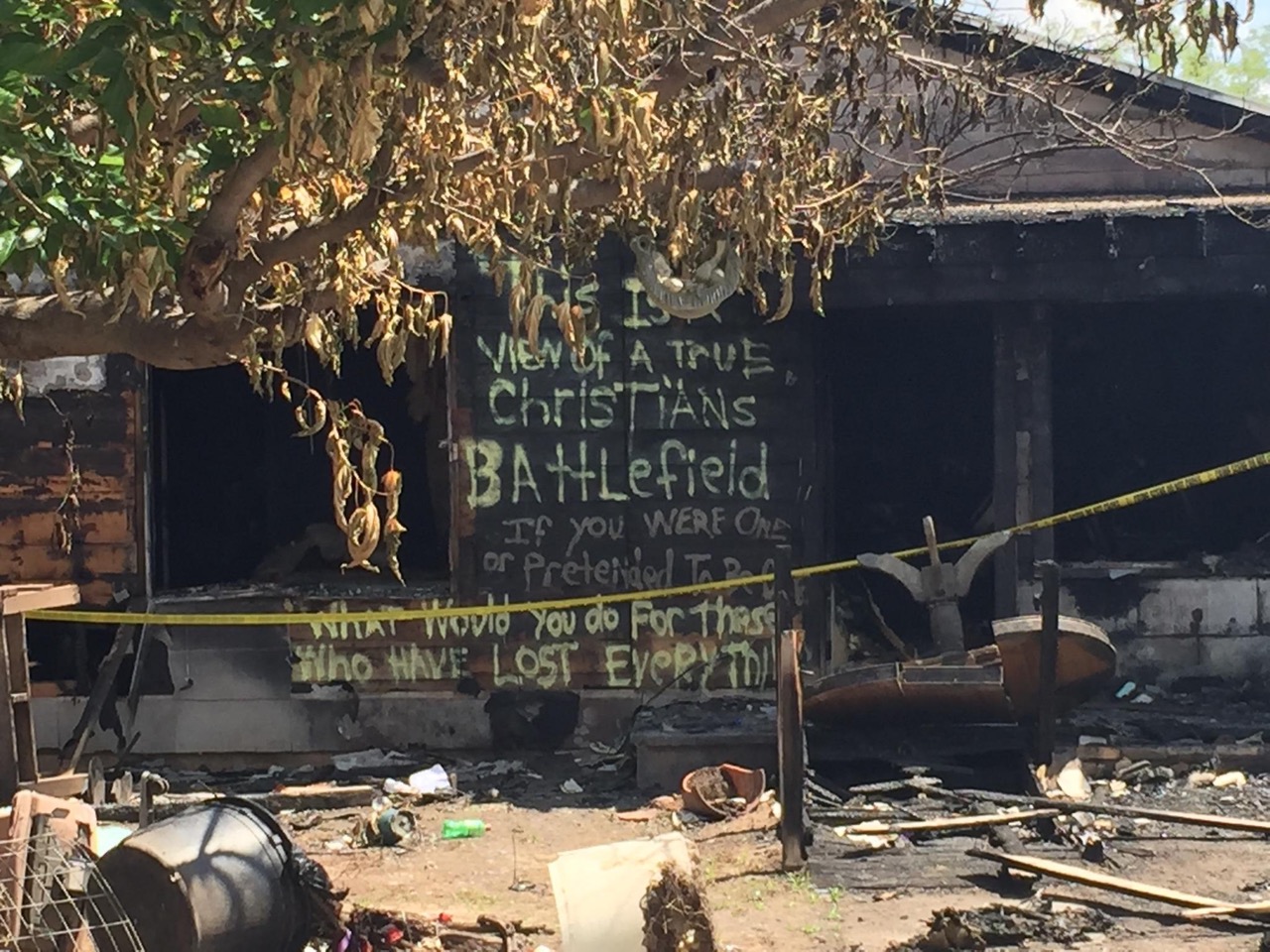 Read closely what the painted words on the condemned house say. (LIVE! Photo/Amanda Henson)