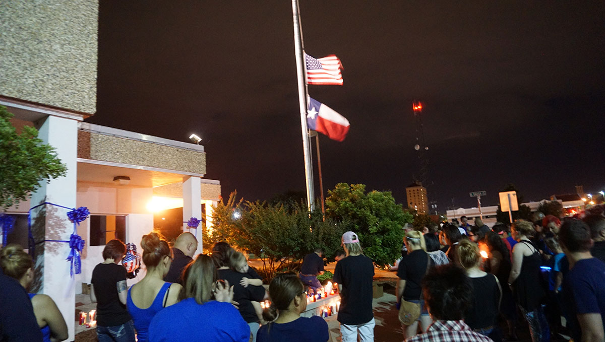 The flags in front of the San Angelo Police Station flew at half staff in honor of their fallen officer. (LIVE! Photo/John Basquez)