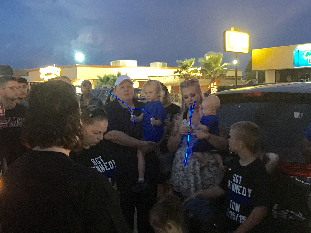 Family, friends and supporters of the San Angelo police gathered on Knickerbocker Road near the crash site Friday night to remember fallen police officer Korby Kennedy. (LIVE! Photo/Amanda Henson)
