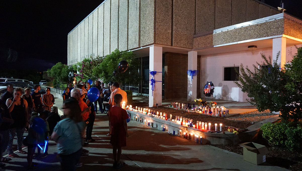 At the police station, candles lined the steps as fellow officers and family remembered fallen officer Korby Kennedy. (LIVE! Photo/John Basquez)