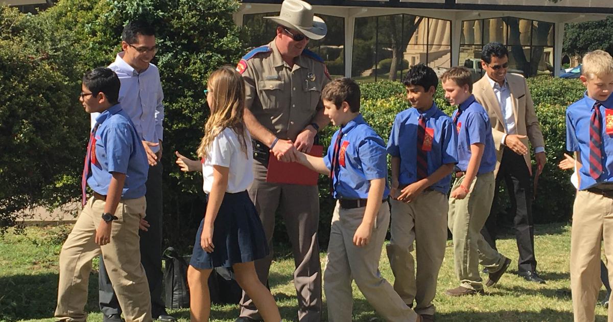 Ambleside students shake hands with Justin Baker and other guest speakers.