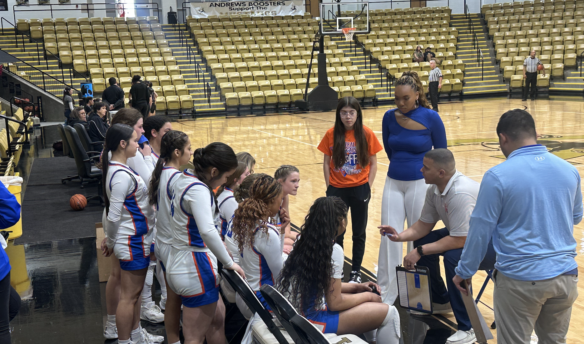 Head Coach Arsenior Geter talks to the Lady Cats during a timeout.