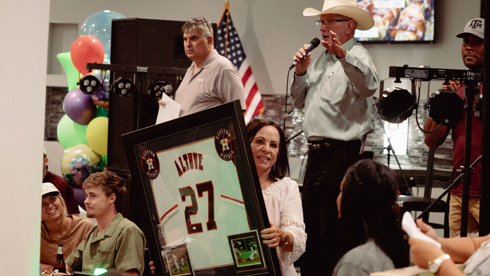 Joe Hyde, auctioneer Mike Smith, and Trish Smith manage the auctioning of a signed Houston Astros jersey donated by singer/songwriter Sterling Elza. Joe Hyde, auctioneer Mike Smith, and Trish Smith manage the auctioning of a signed Houston Astros jersey donated by singer/songwriter Sterling Elza.