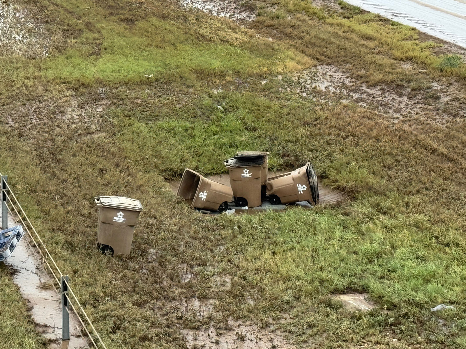 Many Toter trash containers washed into the Houston Harte Expy, likely from the East Ditch. Many Toter trash containers washed into the Houston Harte Expy, likely from the East Ditch.