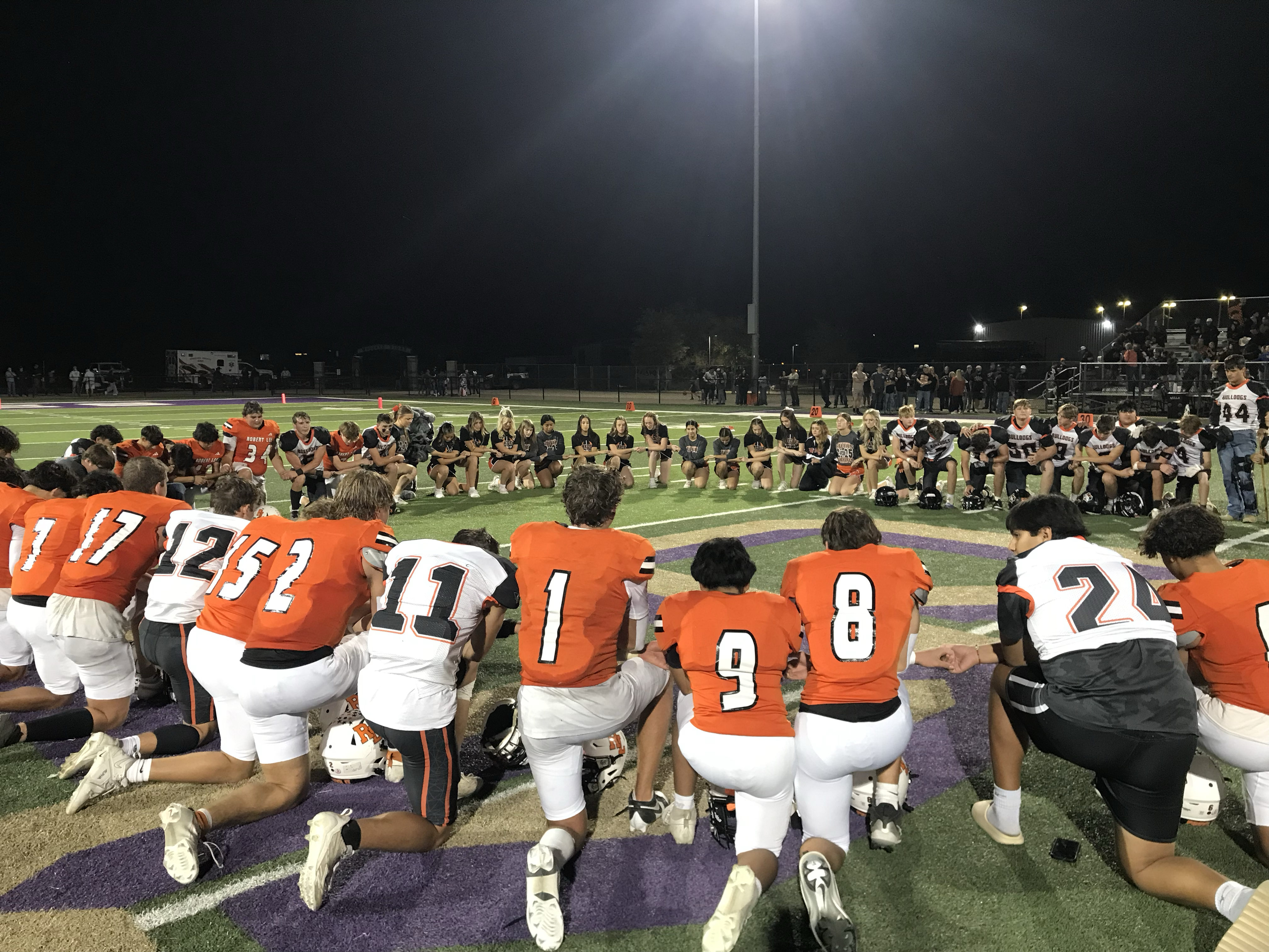 The Robert Lee Steers and Ira Bulldogs pray together after their first-round playoff game Friday, Nov. 14, 2025.