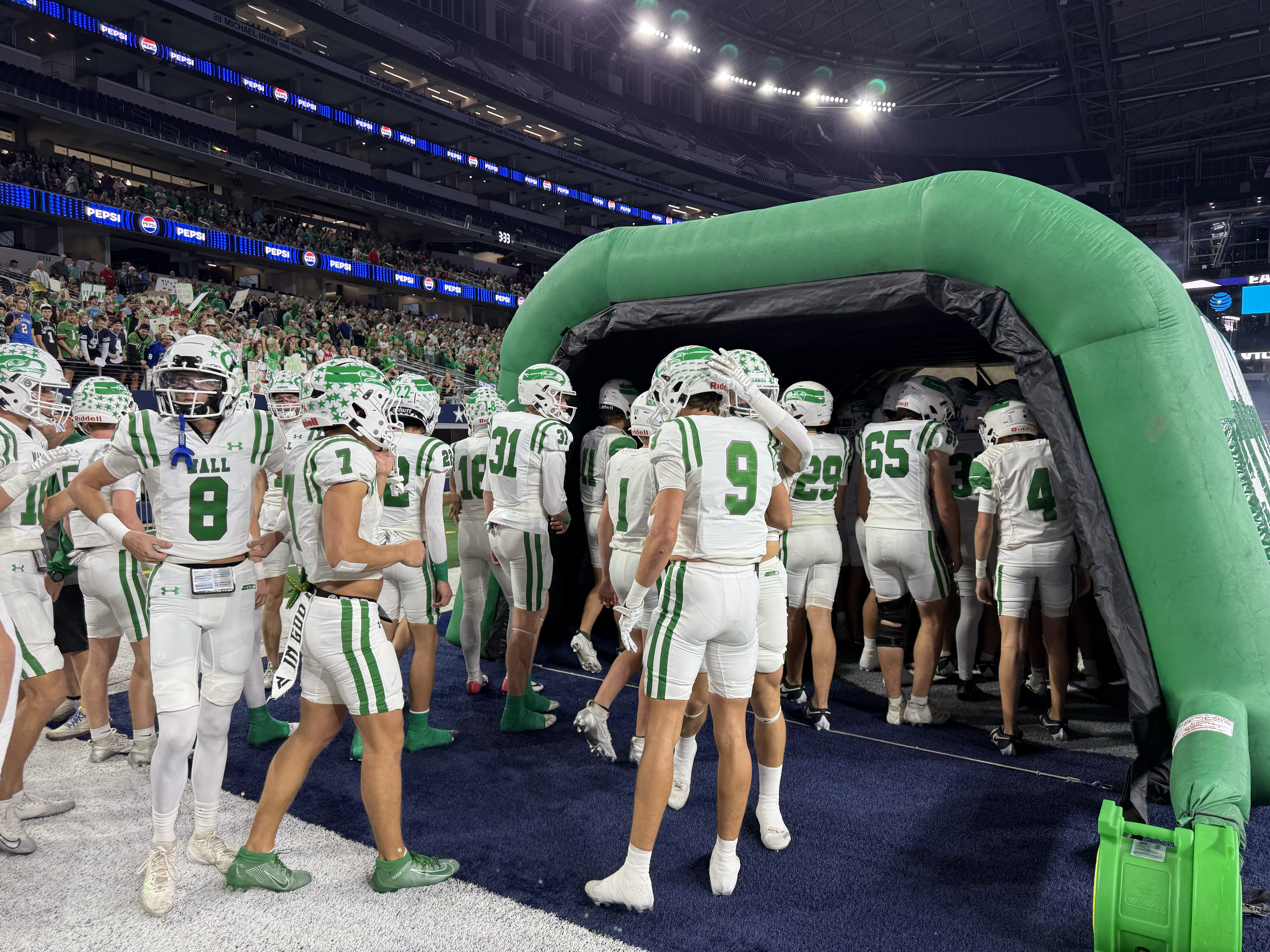 The Wall Hawks prepare to run onto the field before the Class 3A Division II state final against Newton on Thursday, Dec. 18, 2025.