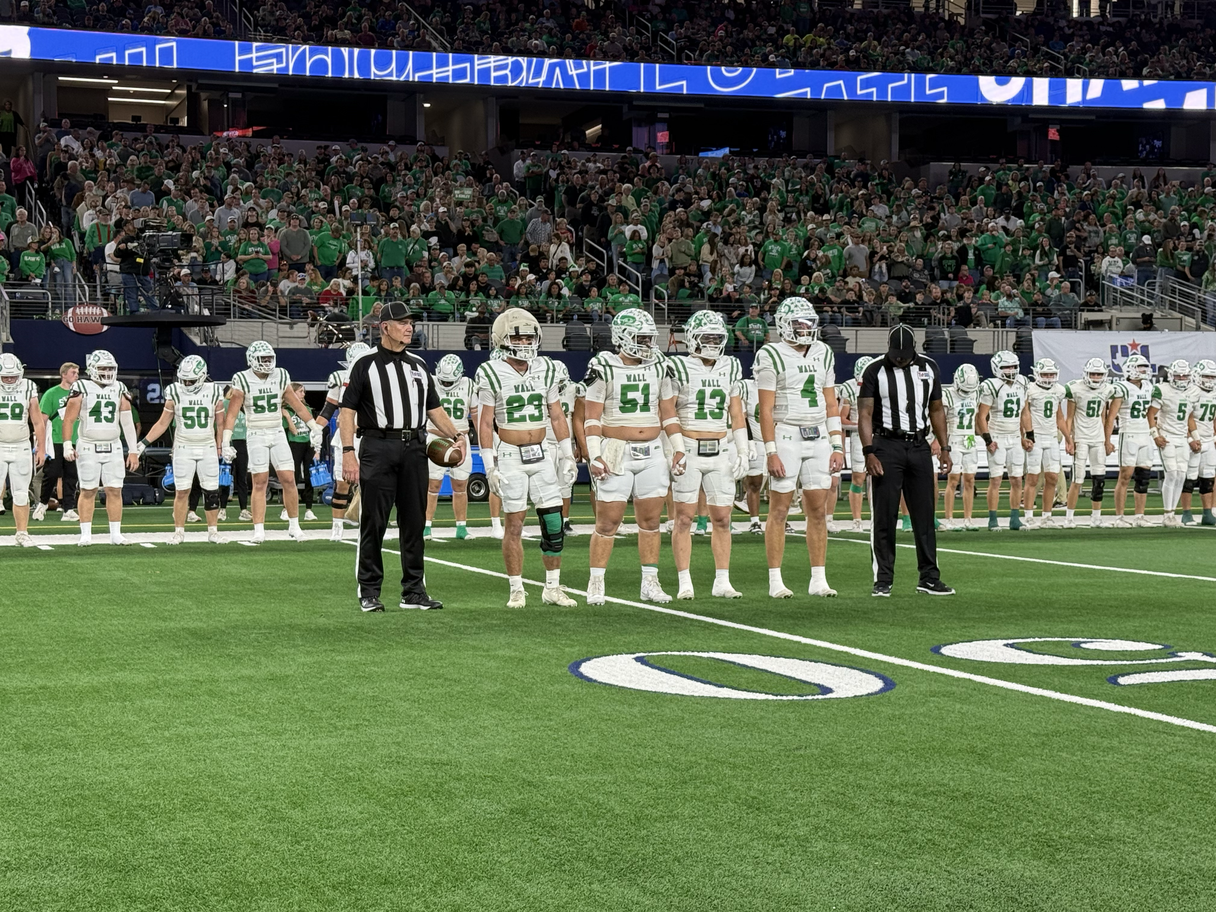 Wall's captains walk to midfield for the coin toss before their Class 3A Division II state final against Newton on Thursday, Dec. 18, 2025.