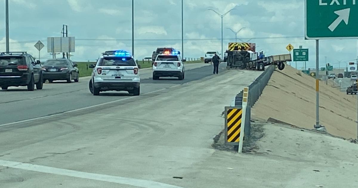 PHOTOS Crash Leaves Trailer Dangerously Dangling Off Guard Rail
