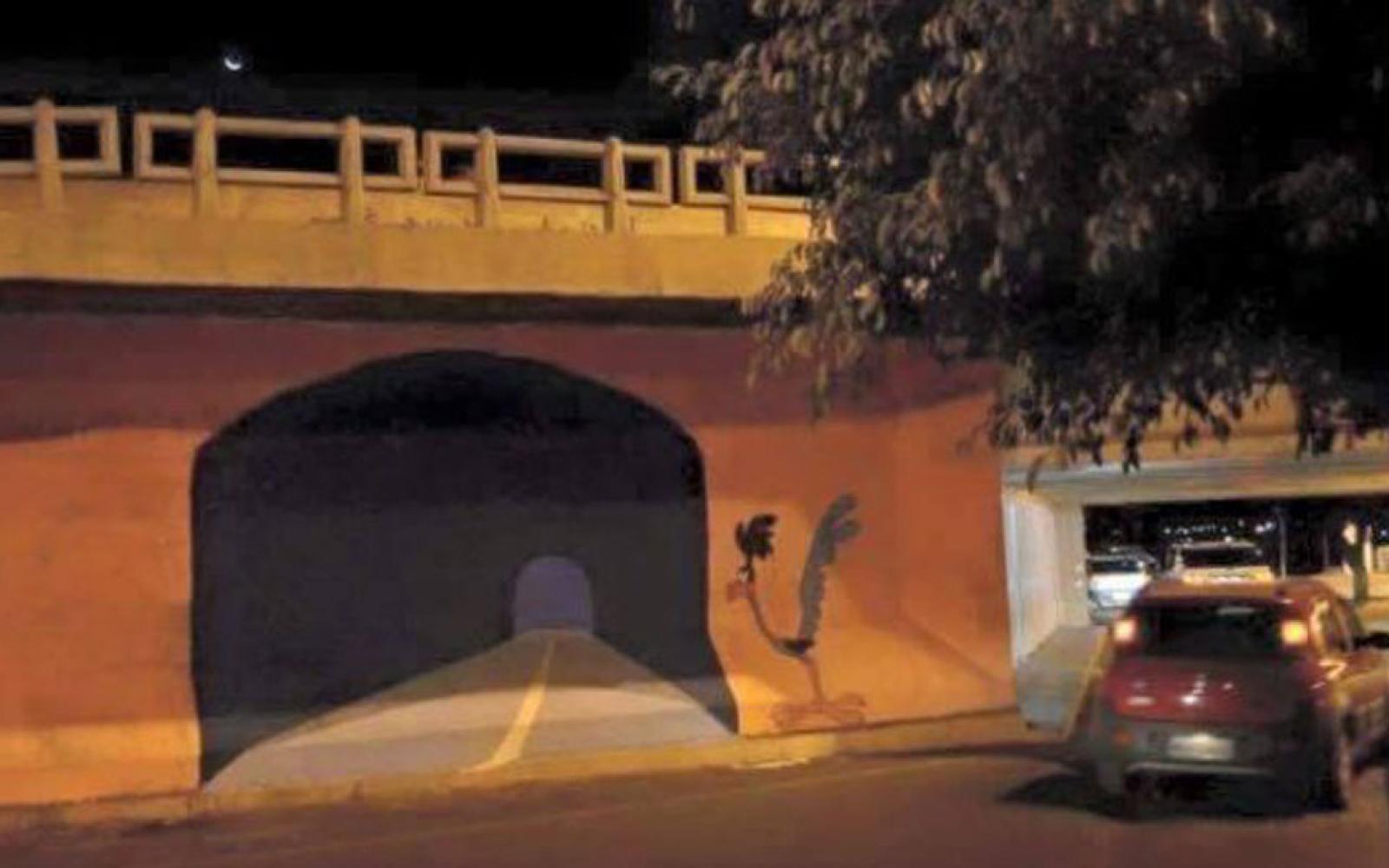 A graffiti artist painted a wall to appear to be a tunnel