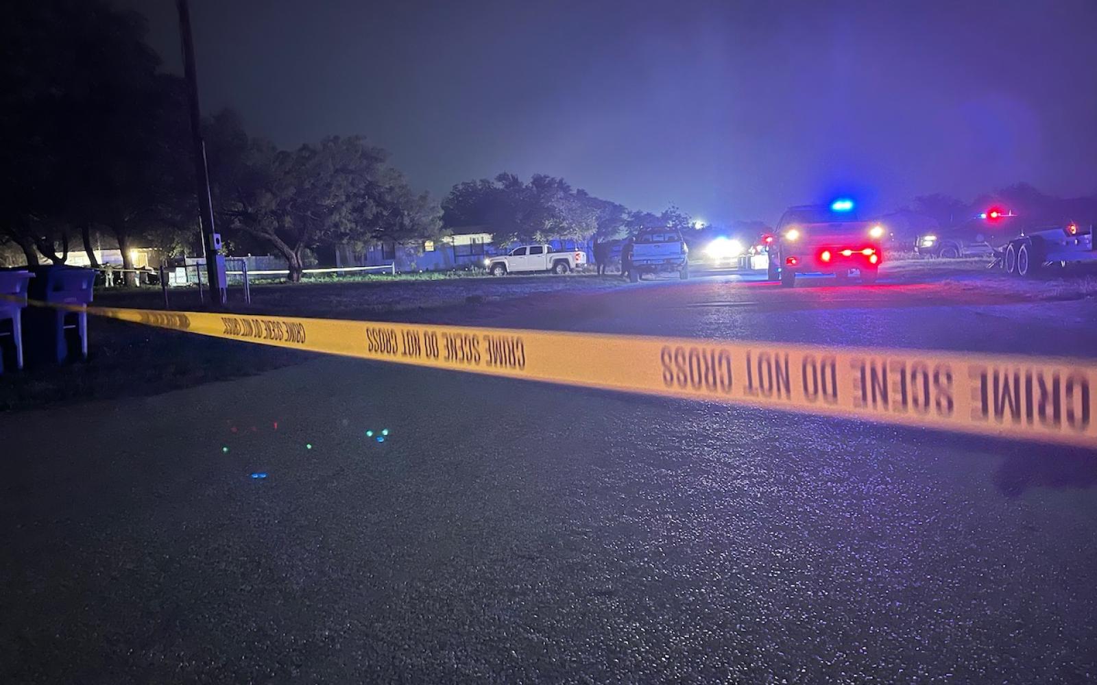 Crime tape blocking off a large area around the house where two law enforcement officers were gunned down the night of May 10, 2021 in Eden, Texas.