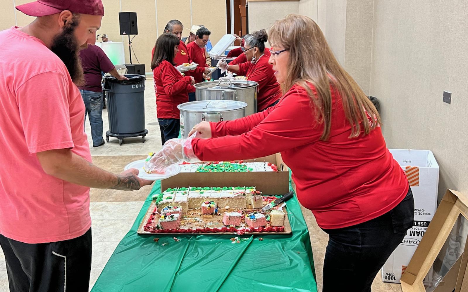 Serving food at the annual Posada on Dec. 10, 2021