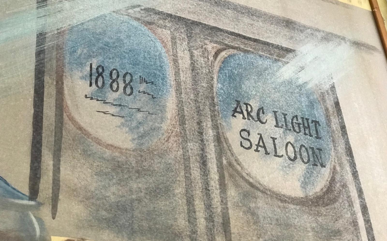 The doors to the former Arc Light Saloon as depicted on the mural. The dates are incorrect. McCloskey didn't arrive in San Angelo until 1892.