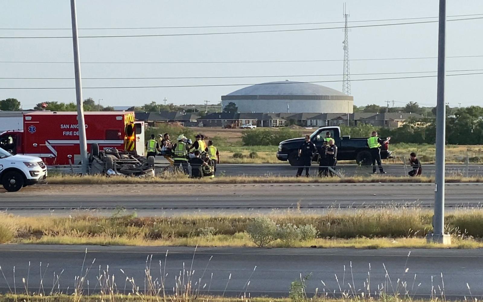 Observe the bent lamp post to the left of the rollover crash vehicle