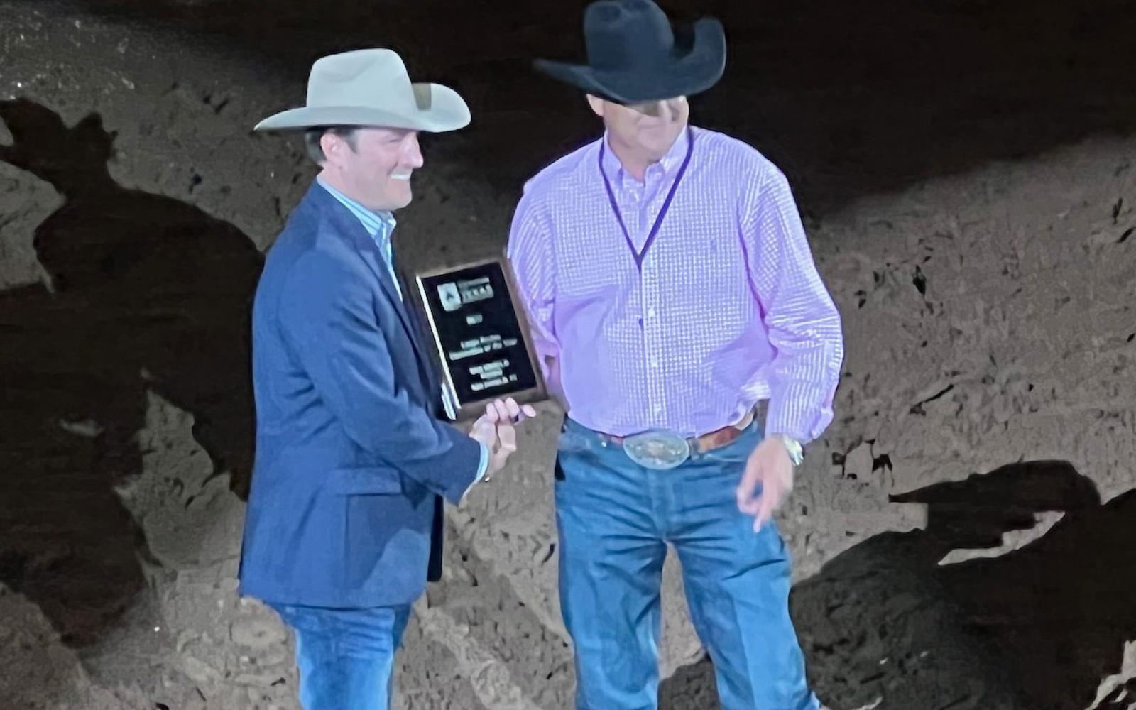 San Angelo Stock Show and Rodeo Assoc. Director Justin Jonas (left) receives the award for "Best Large Rodeo" from the Waco rodeo association president and CEO Wes Allison at the Waco rodeo performance on Oct. 13, 2022.