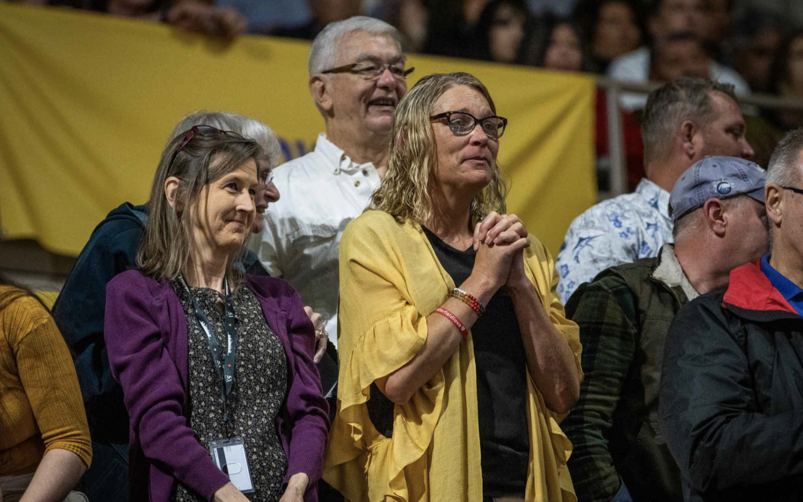 Zach Sutterfield's mom, DJ Sutterfield, watches from the stands as he walks across the stage.