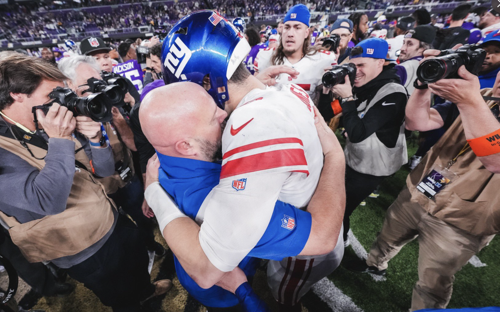 New York Giants Quarterback Daniel Jones embraces Head Coach Brian Dabol after win versus the Vikings