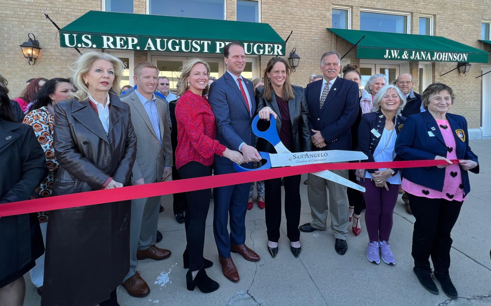 Mayor Brenda Gunter, County Judge Lane Carter, Camille and August Pfluger, Pfluger's Regional Director Karin Kuykendall, and Chamber President Walt Koenig at the ribbon cutting for Pfluger's new office at 124 W. Twohig Ave.