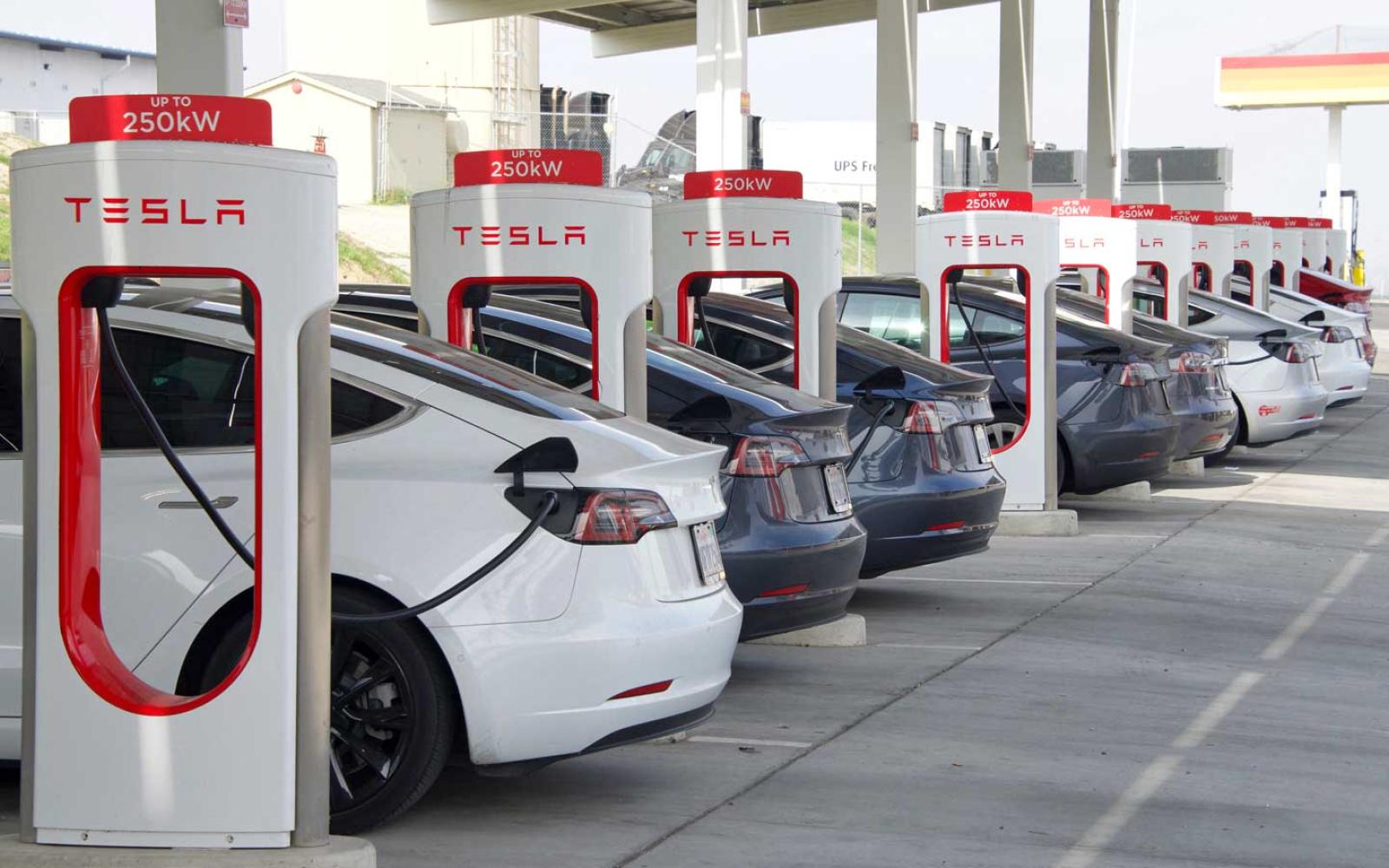 Kettleman City, CA - Jan 29, 2022: Many cars charging at a Tesla Supercharger station. Supercharger stations allow Tesla cars to be fast-charged at the network within a hour.