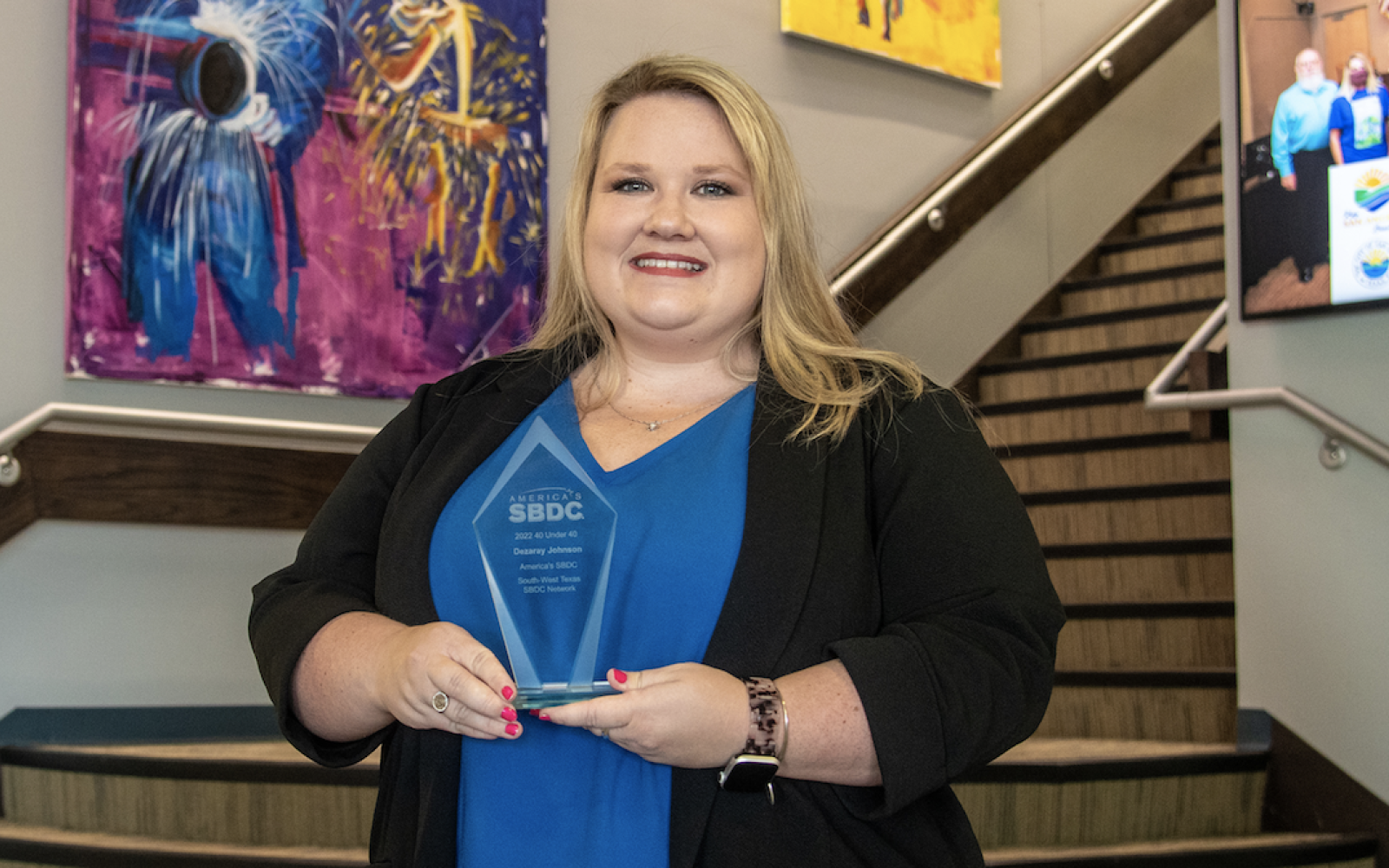 Dezaray Johnson with her Top 40 Under 40 Young Professional Award from America's SBDC
