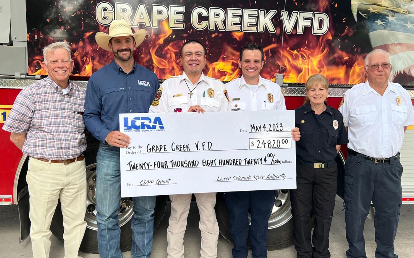 An LCRA representative presents a $24,820 grant to the Grape Creek Volunteer Fire Department for new self-contained breathing equipment for firefighters. The grant is part of LCRA’s Community Development Partnership Program. Pictured, from left to right, are: Rick Bacon, Tom Green County commissioner, Precinct 3; Cooper Hogg, LCRA Regional Affairs representative; José Rivera, deputy fire chief; Aaron Flint, fire chief; Lauren Fortier, VFD treasurer; and Joe Rutherford, captain.
