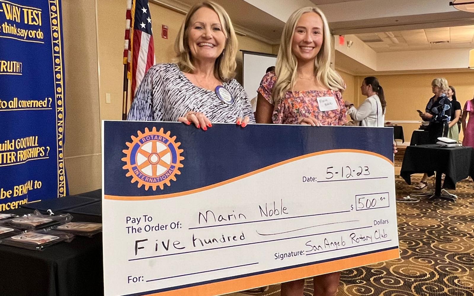 San Angelo Rotary Club President Rochel Ditmore awards a $500 scholarship check to San Angelo Central graduate Marin Noble.