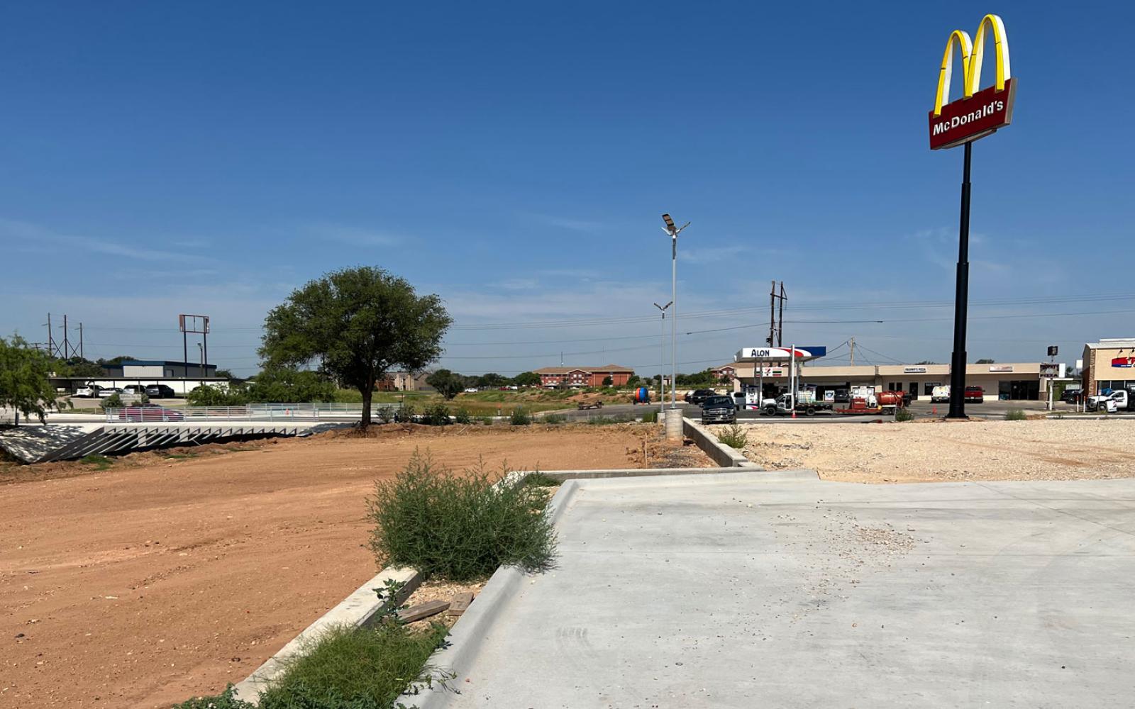 The parking lot area contains two levels. In the left background you can see the new City Southwest Blvd. Red Arroyo crossing bridge.