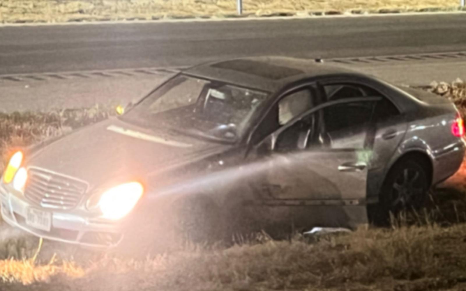 The fleeing driver left the engine running and the lights on. 