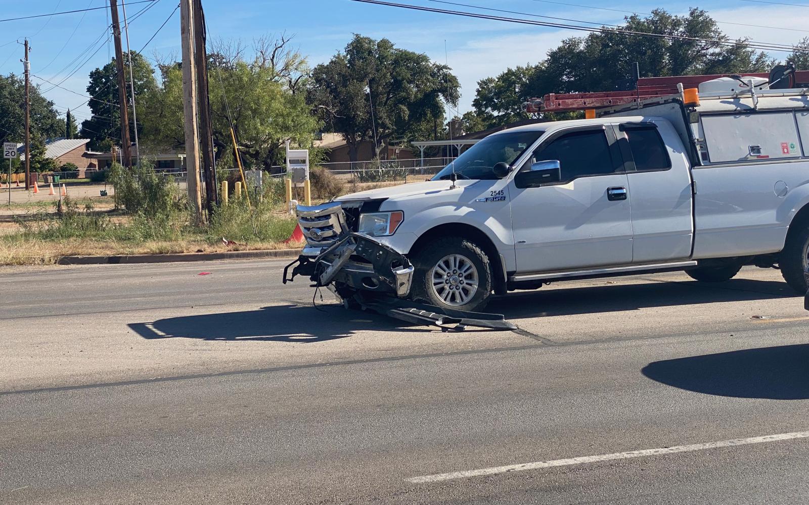 The working man lost the use of his work truck because of the alleged recklessness of the itty-bitty red car driver. Police said the crashed-out car looked like a Toyota.