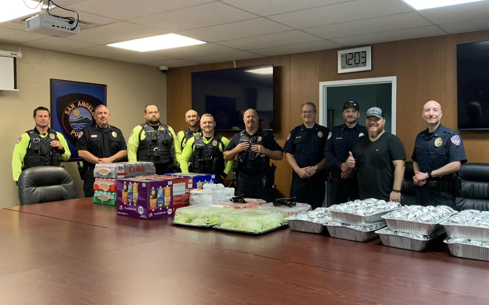 Lonestar Cheeseburger's proprietor Tim Condon, second from right, with members of the San Angelo Police Department.