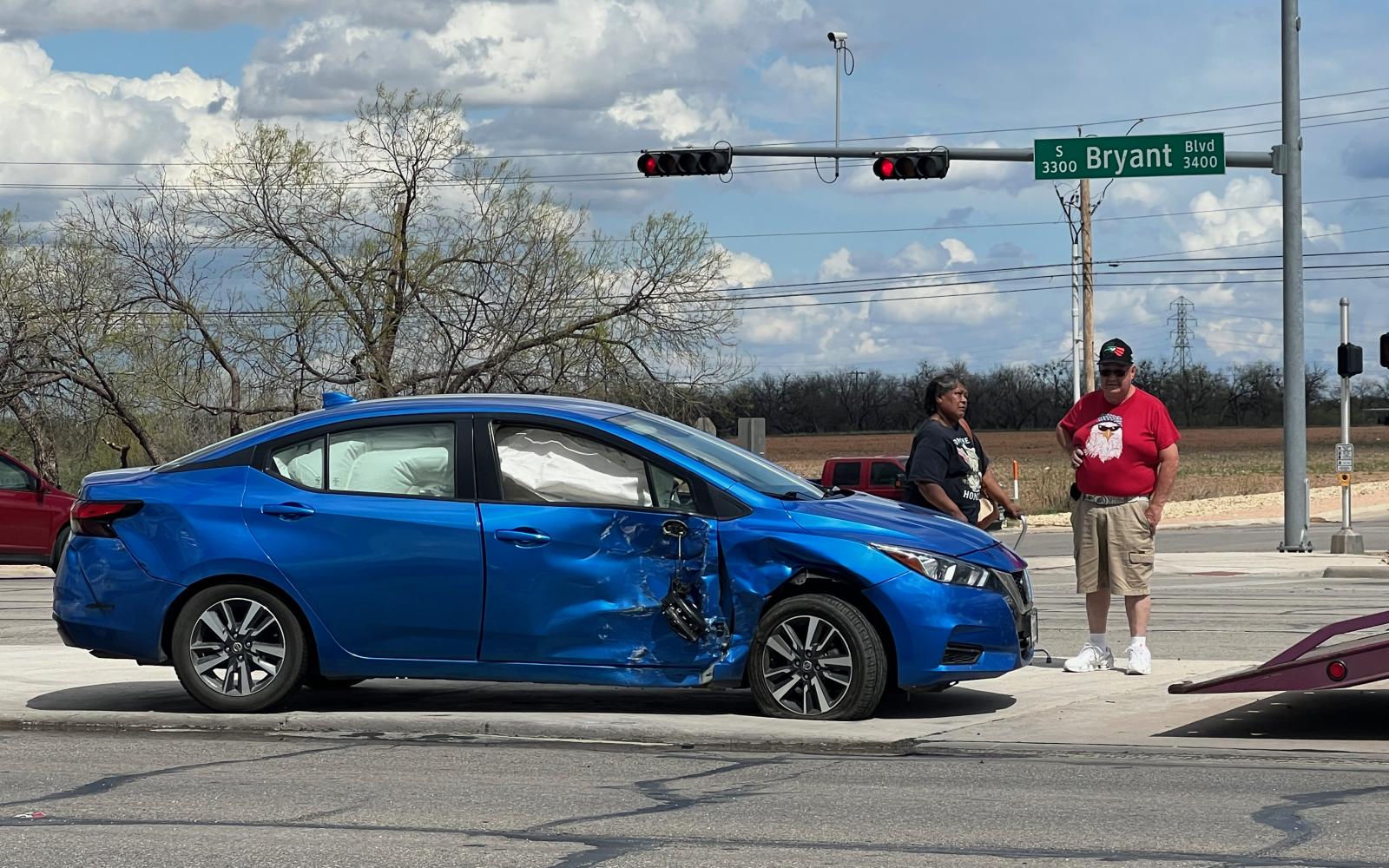 The instigator's bright blue Nissan Versa