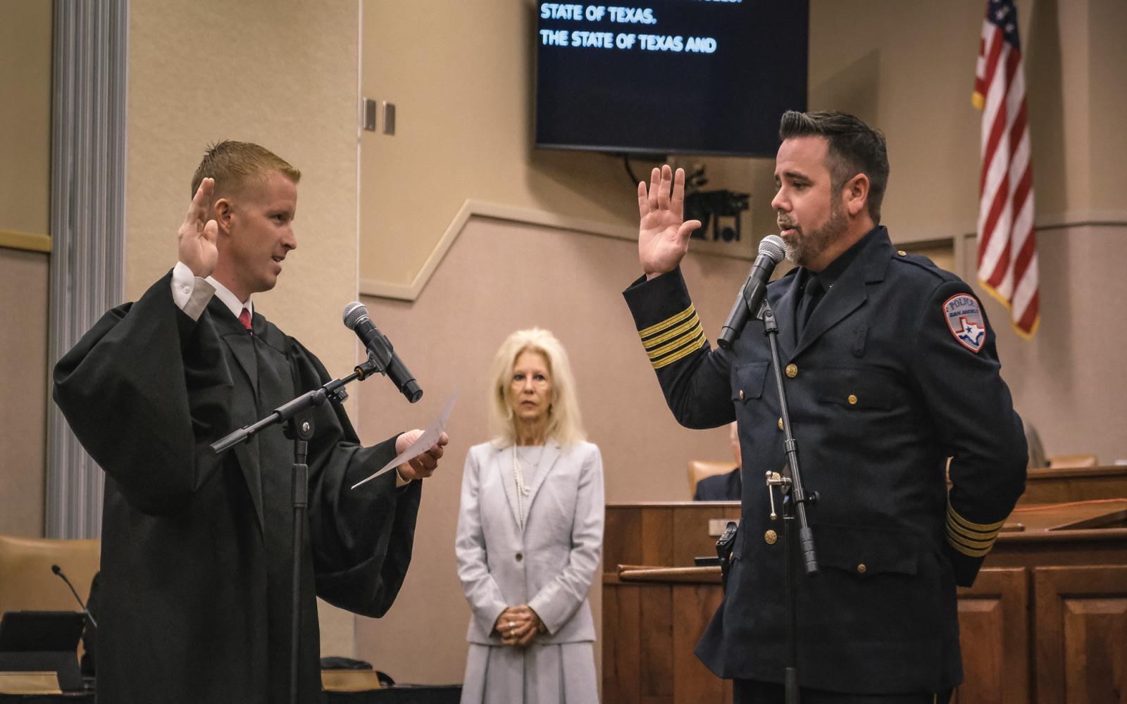 Travis Griffith is sworn in as police chief in late June 2024 by County Judge Lane Carter as Mayor Brenda Gunter looks on. 