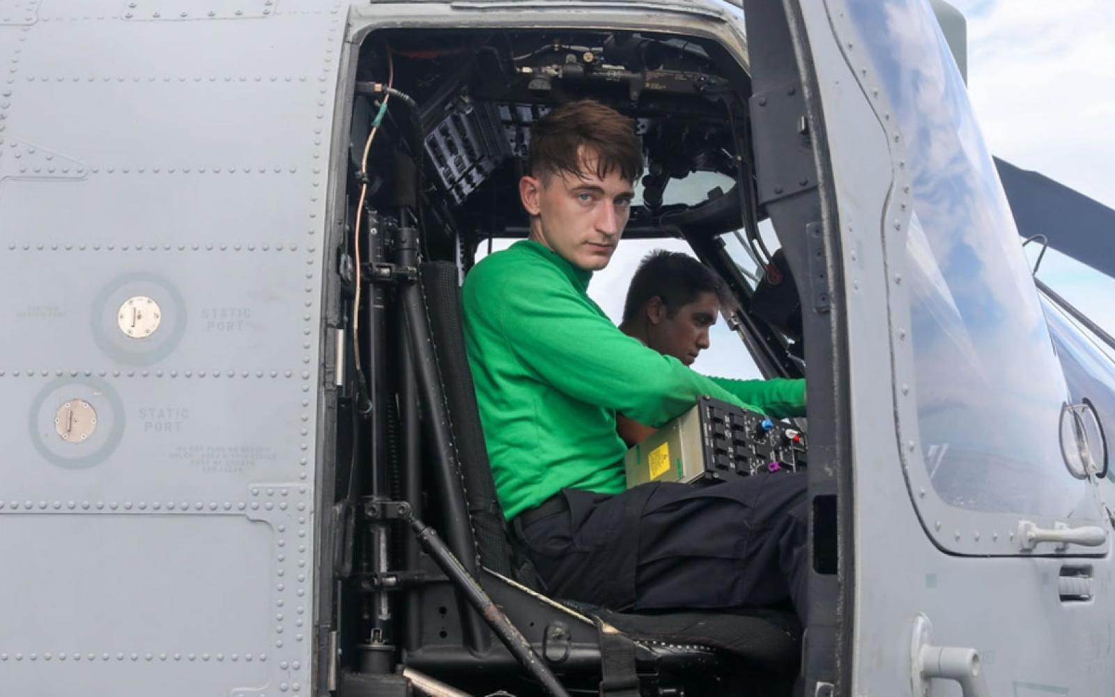 Aviation Electrician’s Mate 2nd Class Isaac Corp, from Florahome, Florida, back, and Aviation Electronics Technician 2nd Class Andrew McConnell, from San Angelo, front, perform routine maintenance on a Sea Hawk helicopter (MH-60R) on the flight deck aboard the Arleigh Burke-class guided-missile destroyer USS Howard (DDG 83) in the South China Sea, July 9. Howard is forward-deployed and assigned to Destroyer Squadron (DESRON) 15, the Navy’s largest DESRON and the U.S. 7th Fleet’s principal surface force. 