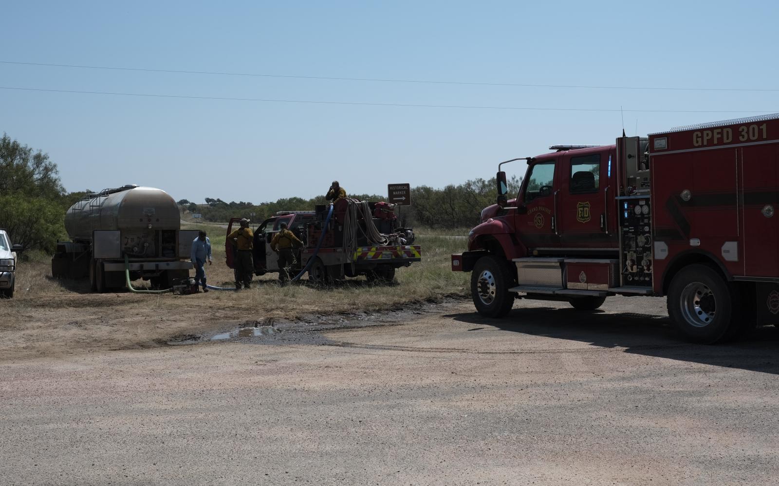 Volunteer firefighters prepare to head back out to help battle the "North Art Complex" fire outside Mason on Friday, Aug. 23.
