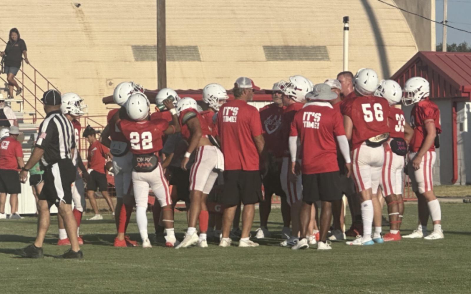 The Miles Bulldogs huddle up in a 2023 scrimmage.