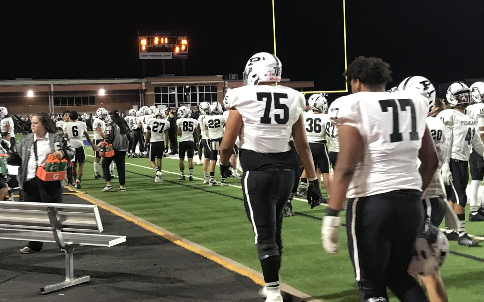 Odessa Permian's offensive linemen, including 6-foot-7, 305-pound Hector Vasquez (74), walk to the bench during their game against Central on Friday, Oct. 18, 2024, at San Angelo Stadium.