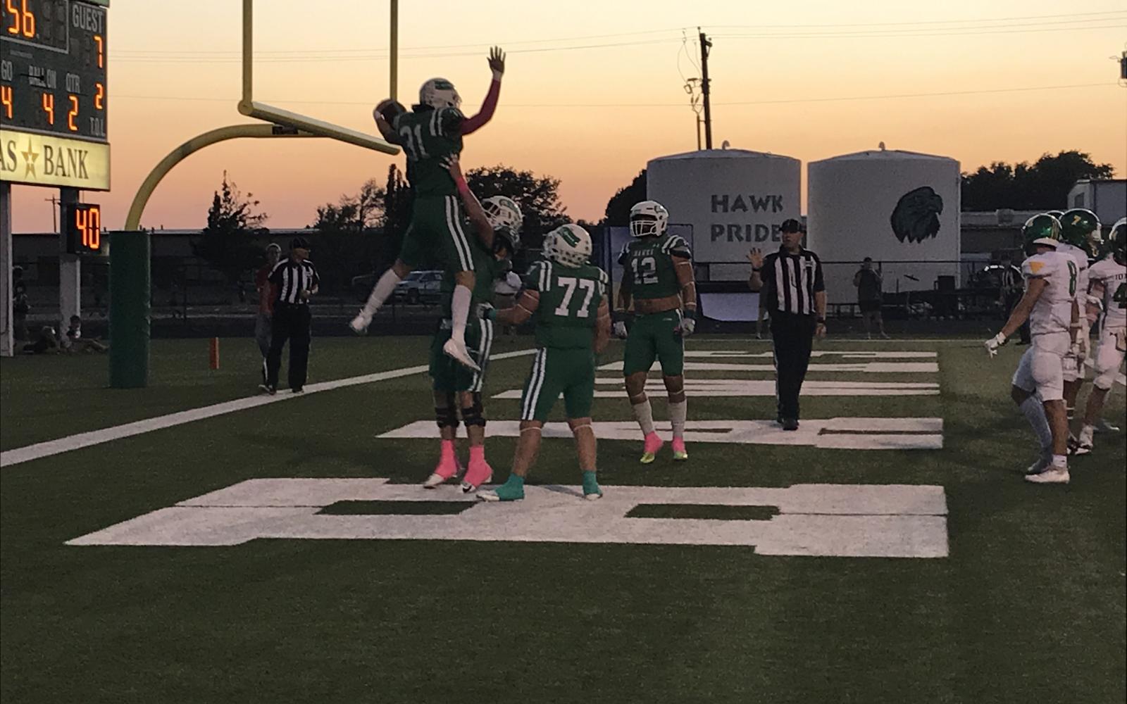 Wall's Ethan Michalewicz is picked up by Ben Taylor after a touchdown against Idalou on Friday, Oct. 4, 2024.