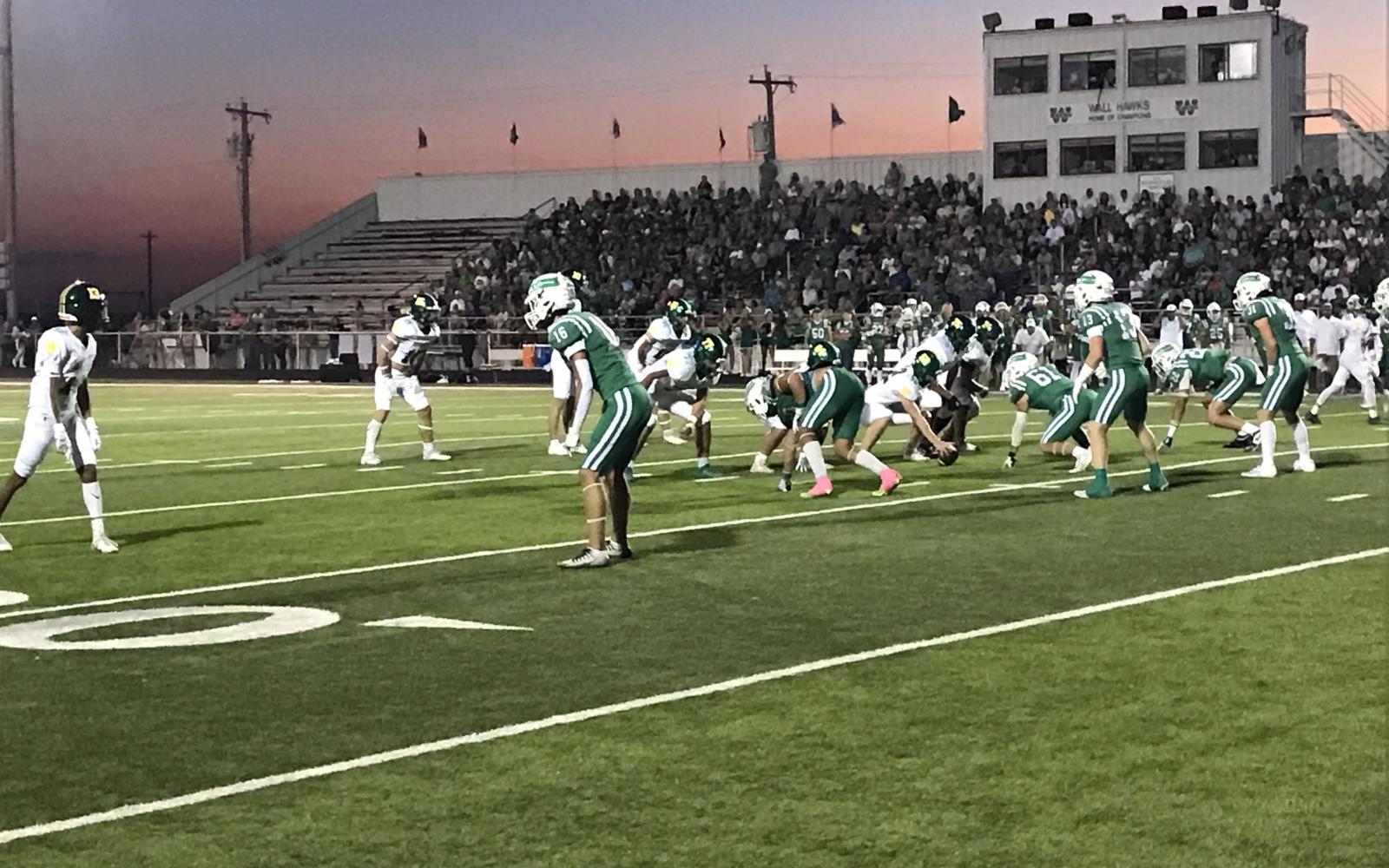 The Wall Hawks' defense prepares for the snap against Idalou on Friday, Oct. 4, 2024.