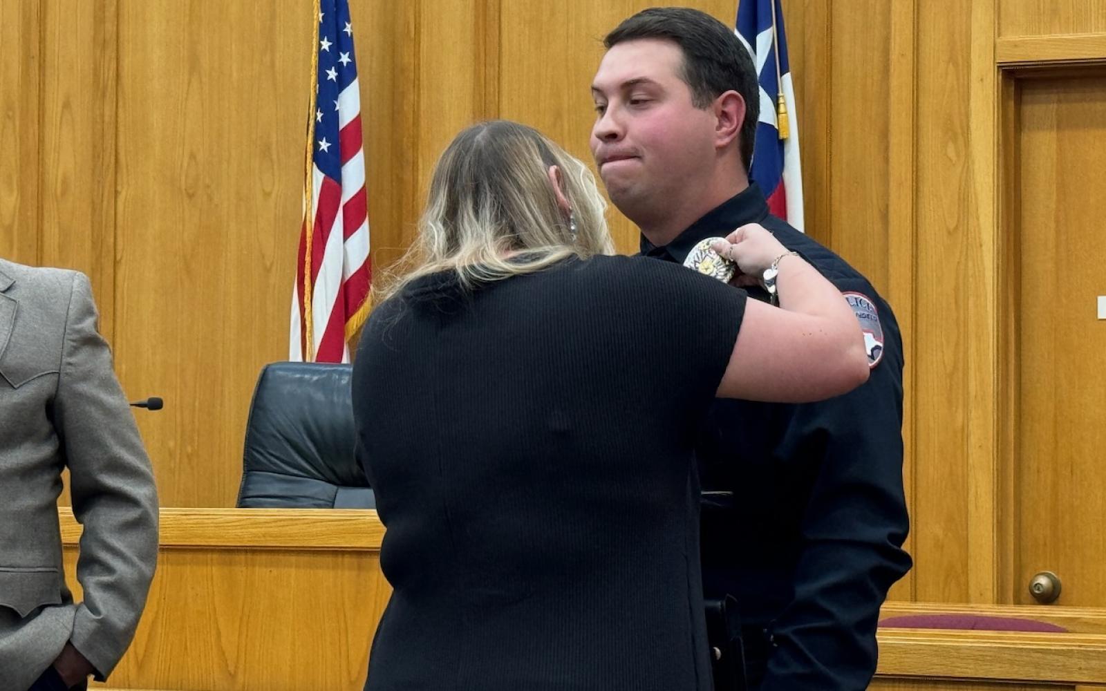 Deyna Bilbo pins the San Angelo Police Department Badge on her husband, Israel, who transferred into the SAPD on Nov. 1, 2024.