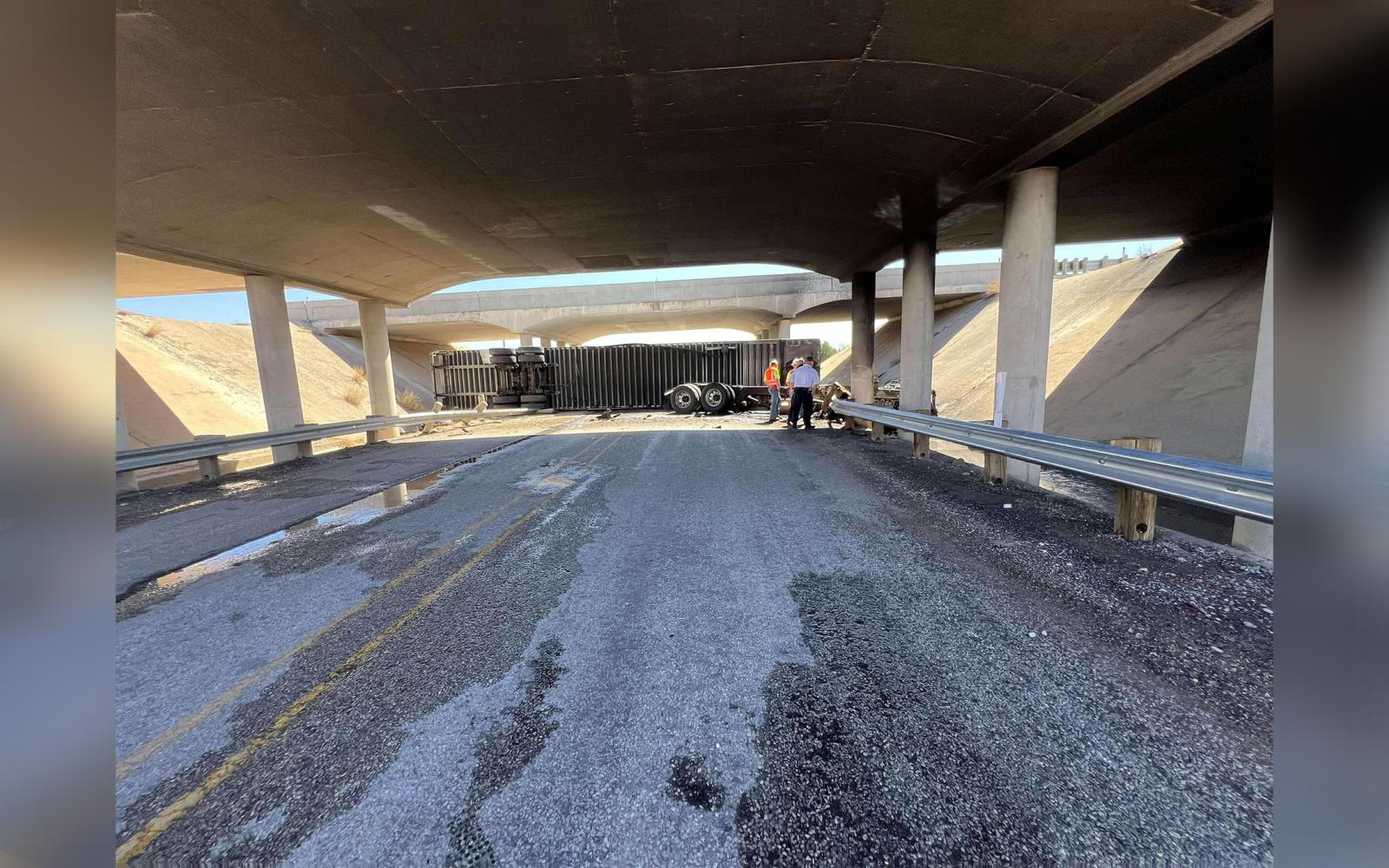 Emergency crews assess the wreckage of an overturned truck under the I-20 overpass. Traffic was reduced to one lane in both directions as cleanup continued. (Photo: Roscoe Volunteer Fire Department)