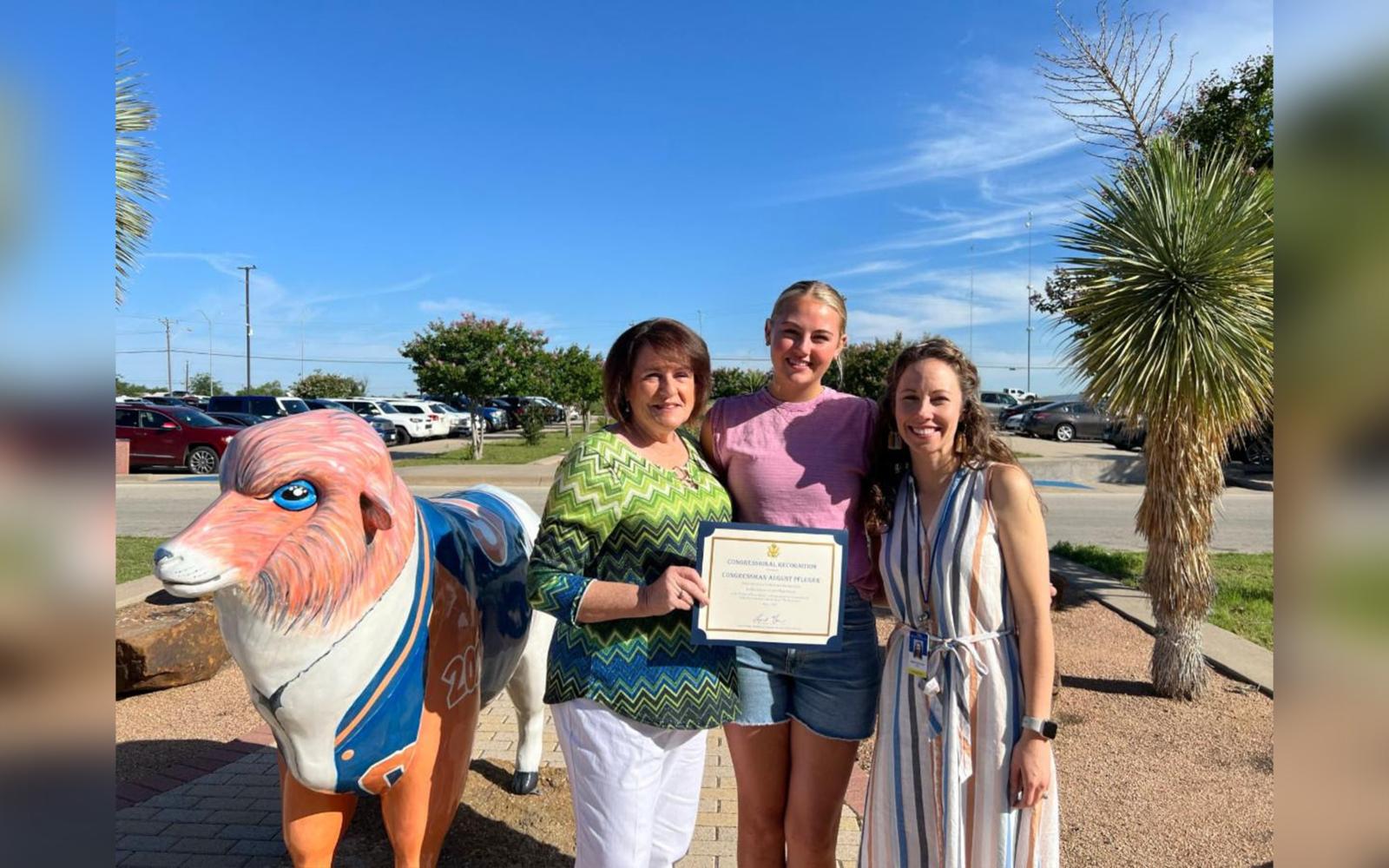 Pictured: Korbin Jastrow (middle) being presented her winning certificate alongside Central High School art teacher Heather Shoop-York (right) and Congressman Pfluger's San Angelo Regional Director Kathy Keane (left). 