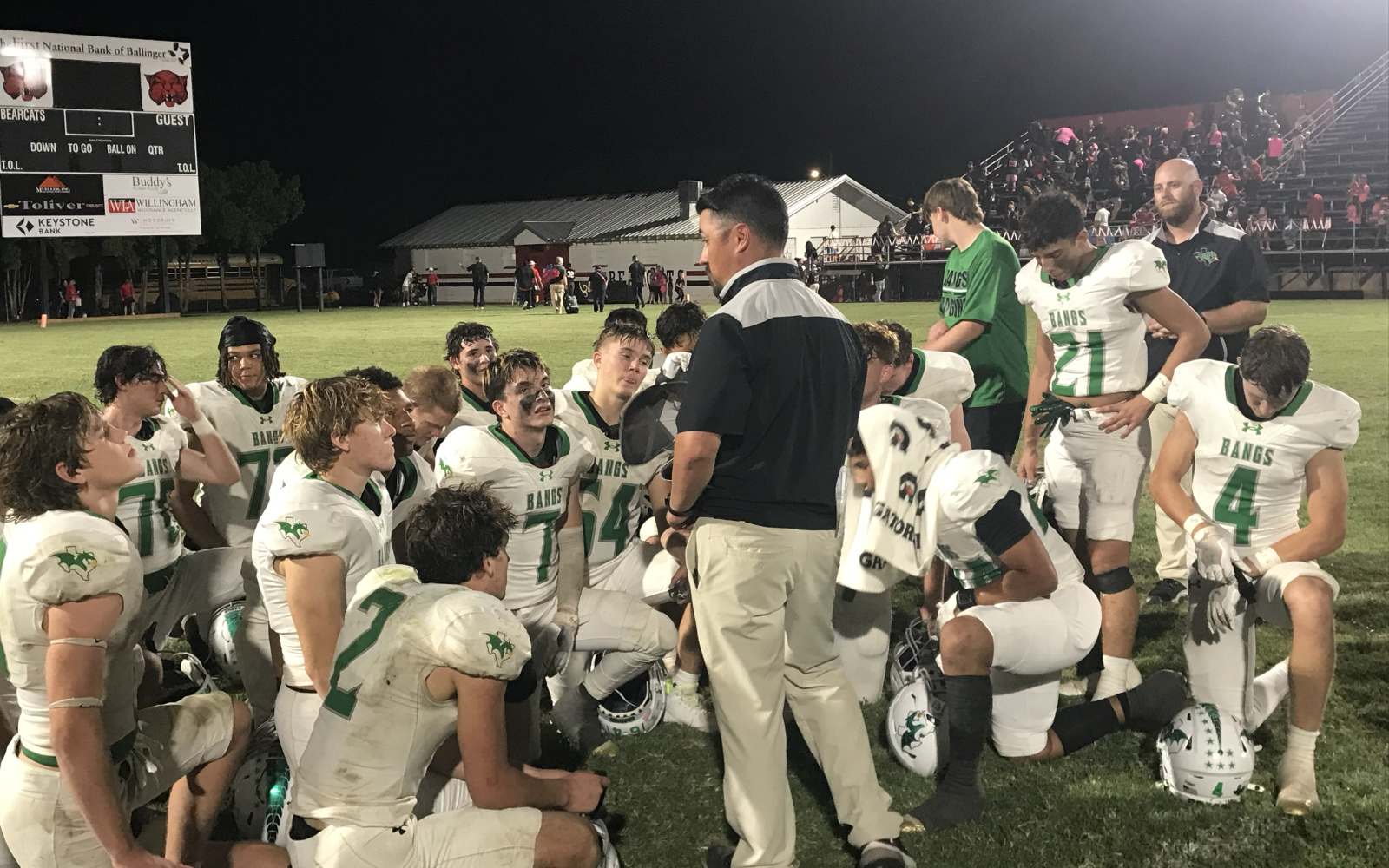 The Bangs football team listens to head coach Colton Buzzard following their 48-0 win over Ballinger on Friday, Oct. 10, 2025.