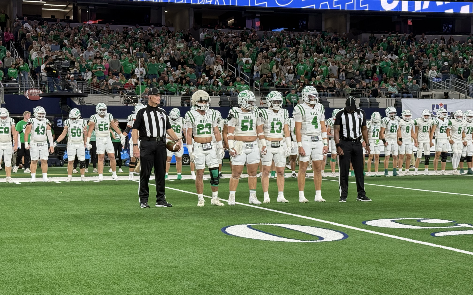Wall's captains walk to midfield for the coin toss before their Class 3A Division II state final against Newton on Thursday, Dec. 18, 2025.