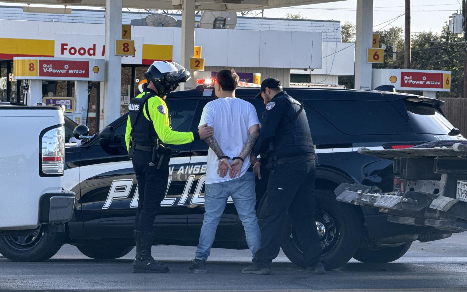 A man was observed in handcuffs being placed in the back of a police vehicle after a rollover crash Thursday, Jan. 8, 2025.