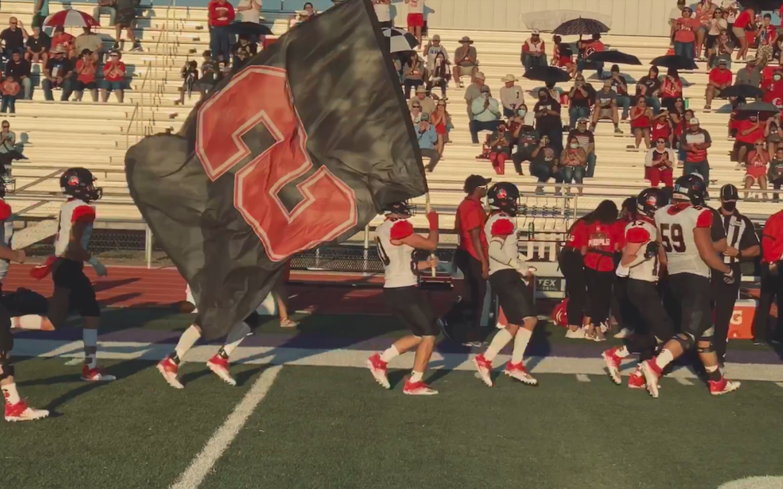The Sonora Broncos charge onto the field before a game in 2020.