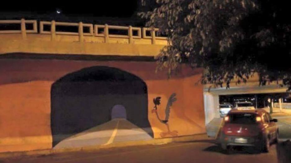 A graffiti artist painted a wall to appear to be a tunnel A graffiti artist painted a wall to appear to be a tunnel