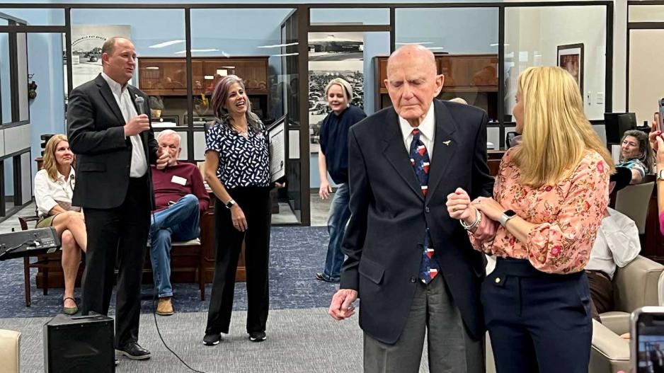 Texas Bank President Casey Barrett (left with mic) emcees the bank's 60th Anniversary party where John Mark McLaughlin was recognized. Mr. McLaughlin is standing with his granddaughter, Claire McLaughlin, who is an attorney in Midland. Texas Bank President Casey Barrett (left with mic) emcees the bank's 60th Anniversary party where John Mark McLaughlin was recognized. Mr. McLaughlin is standing with his granddaughter, Claire McLaughlin, who is an attorney in Midland.