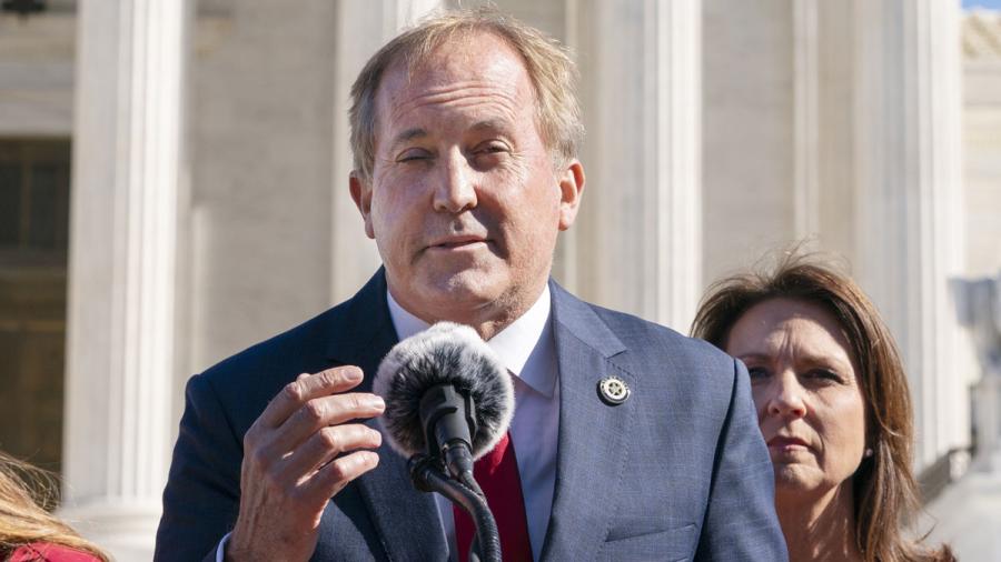 Texas Attorney General Ken Paxton, left, next to his wife and Texas State Sen. Angela Paxton, speaks to anti-abortion activists at a rally outside the Supreme Court, Monday, Nov. 1, 2021, on Capitol Hill in Washington. (AP Photo/Jacquelyn Martin)