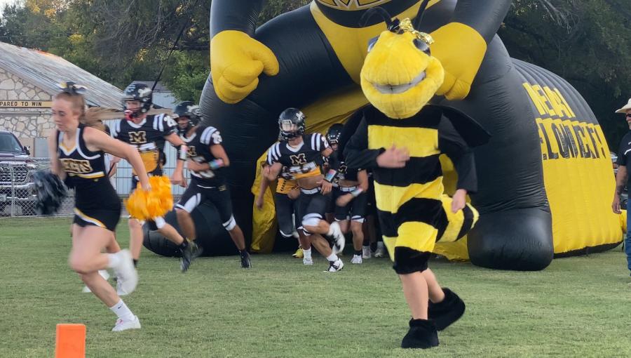 The Menard Yellow Jackets run onto the field before a game against Rocksprings during the 2025 season.